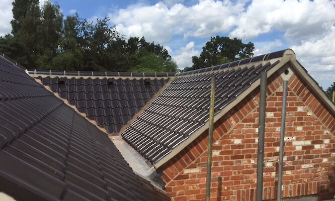 Roofer in Norfolk completing tiled roof repairs