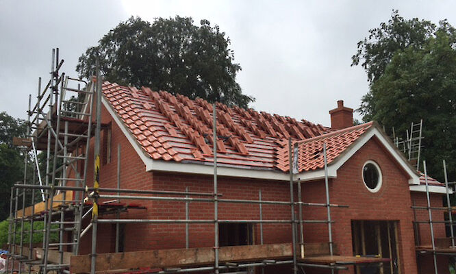 Roofer in Norwich completing tiled roof repairs